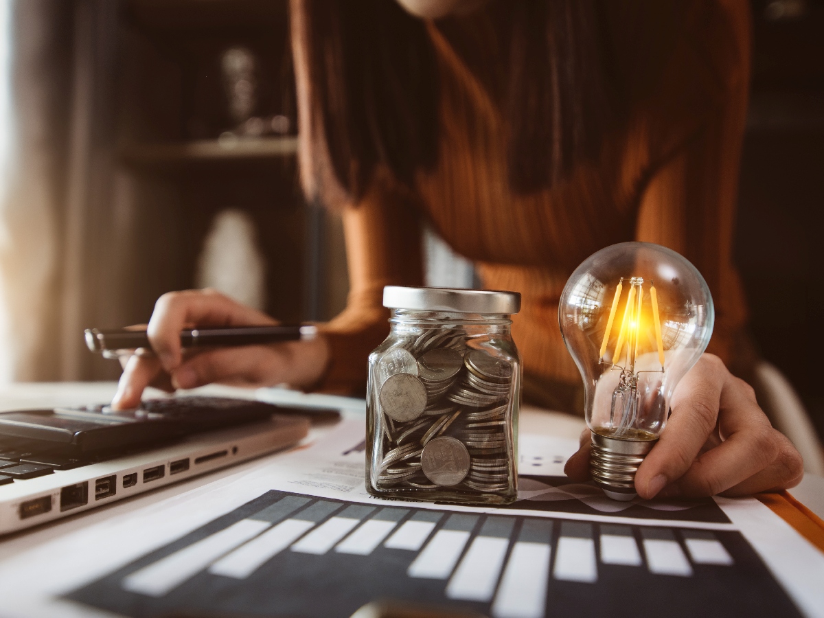 coins in a jar surrounded by spreadsheets