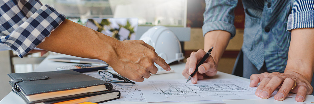 two men looking at designs