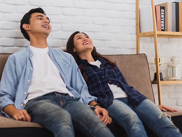 Asian couple looking up at ceiling